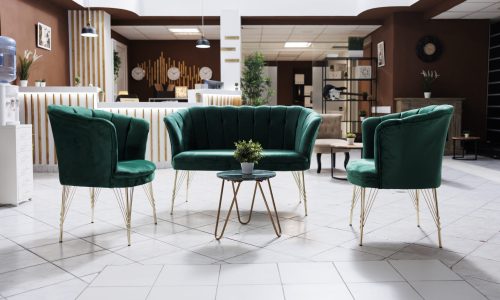 Empty lounge area in hotel lobby with modern furniture and marble floors used to welcome guests and do accommodation check in. Spacious luxury resort entrance with expensive rooms.